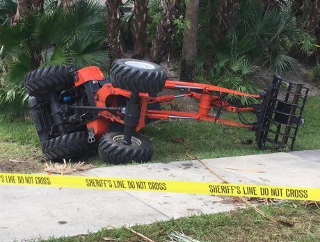 Tractor overturns, traps man