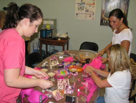 Team members bedazzle at Pink Bra Party for Making Strides Against Breast Cancer