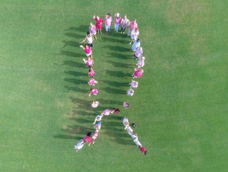 Human pink ribbon raises breast cancer awareness