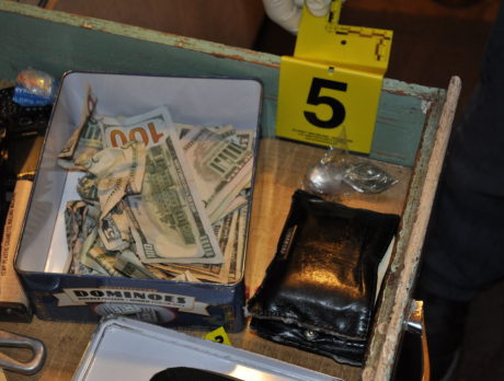 Guns, drugs, and money seized in raid