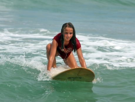 Surfer braves jellyfish filled waters