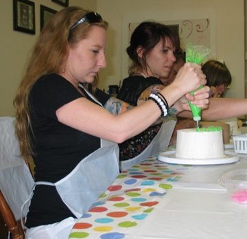 Children of all ages decorate cakes for their moms at Sweet Creations