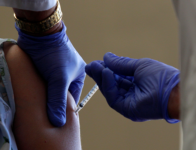 Number of COVID-19 vaccinations rises as infections here set new record