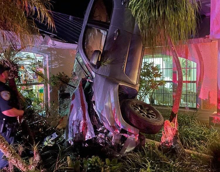 Woman hurt after truck flips onto home