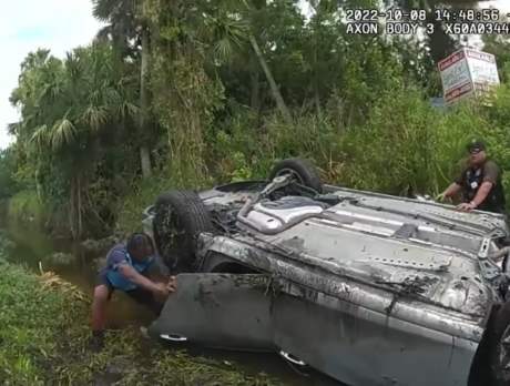 Body-camera footage captures rescue after car flips in canal