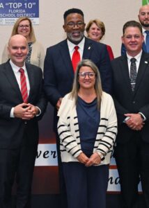 Sara Milliman, executive assistant to Eric Seymour, poses for a group photo at the Dec. 9 school board meeting in Indian River County. PHOTO PROVIDED