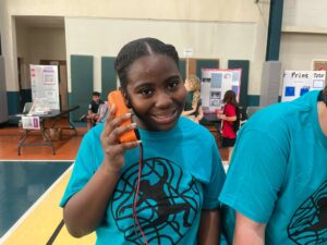 GYAC eighth-grader Melania Warner listens for beeps on the digital multimeter to check if there is a short circuit or a connected circuit. PHOTO BY NICK SAMUEL